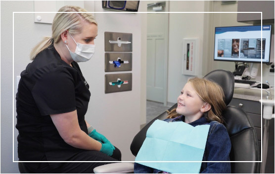 dental assistant with young patient